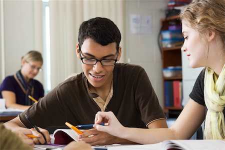 Classmates working on mathematics assignment together Stock Photo - Premium Royalty-Free, Code: 632-03516545