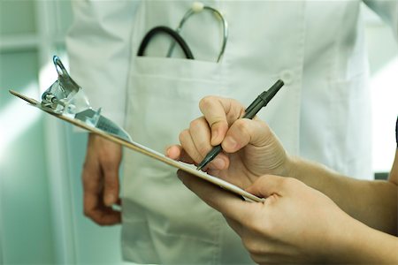 signing the documents - Patient completing medical paperwork Stock Photo - Premium Royalty-Free, Code: 632-03516719