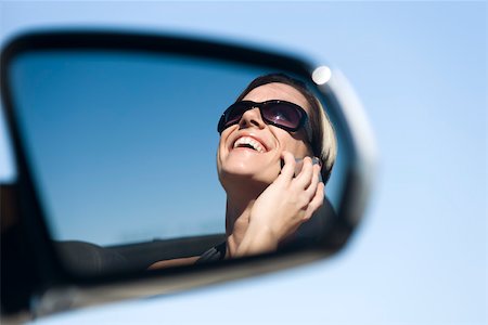 sideview mirror woman not man - Woman talking on cell phone, reflection in side-view mirror Stock Photo - Premium Royalty-Free, Code: 632-03516814