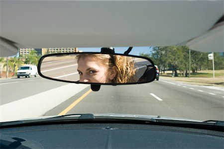 simsearch:632-03500891,k - Woman driving, checking rear view mirror Fotografie stock - Premium Royalty-Free, Codice: 632-03516816