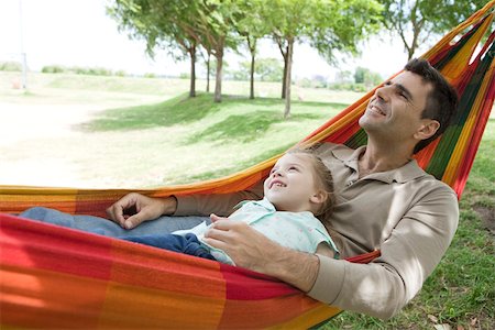 Father and young daughter relaxing together in hammock Stock Photo - Premium Royalty-Free, Code: 632-03517004