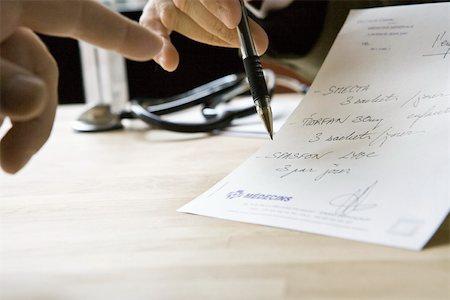 pen and prescription - Doctor explaining prescription to patient, cropped Stock Photo - Premium Royalty-Free, Code: 632-03629675