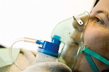 female in on oxygen mask for breathe - Patient wearing oxygen mask, close-up Stock Photo - Premium Royalty-Free, Code: 632-03629695