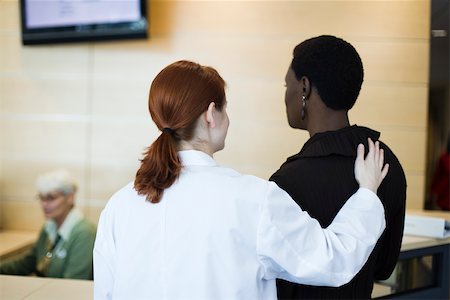 ponytail back view - Female healthcare worker reassuring patient Stock Photo - Premium Royalty-Free, Code: 632-03629873