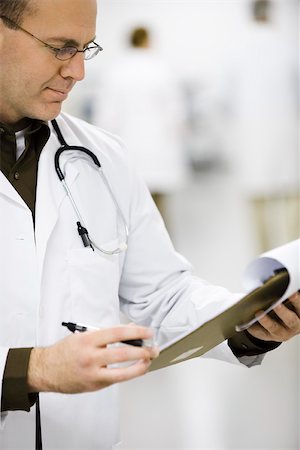 reading glasses top view - Doctor looking at medical chart Stock Photo - Premium Royalty-Free, Code: 632-03629900