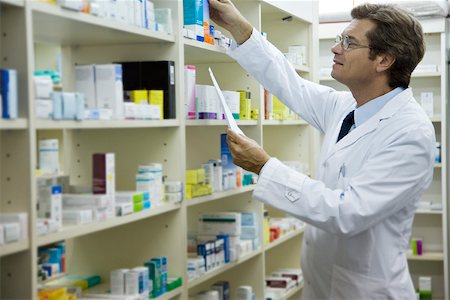 pharmacy shelf - Pharmacist checking shelf for medication Stock Photo - Premium Royalty-Free, Code: 632-03630018