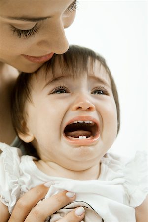 Mother holding crying infant Foto de stock - Sin royalties Premium, Código: 632-03630091