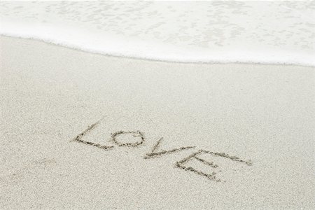 The word "love" written in the sand at the beach Stock Photo - Premium Royalty-Free, Code: 632-03630257