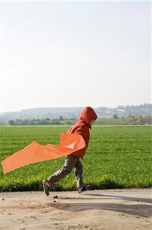 profile of boy jumping - Child running with plastic bag Stock Photo - Premium Royalty-Free, Code: 632-03651653