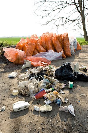 rubbish bag - Trash dumped outdoors, full bags of trash in background result of cleanup effort Stock Photo - Premium Royalty-Free, Code: 632-03651664