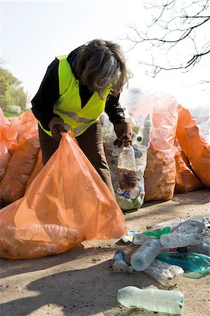 people picking up trash - Woman collecting plastic bottles to recycle Stock Photo - Premium Royalty-Free, Code: 632-03651689