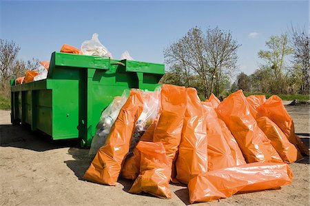 environmental pollution of garbage - Garbage bags piled beside dumpster Stock Photo - Premium Royalty-Free, Code: 632-03651691