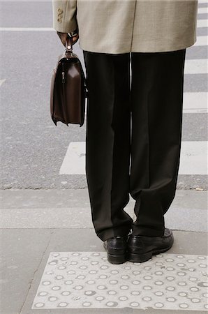 people waiting to cross street - Pedestrian waiting at crosswalk, cropped Stock Photo - Premium Royalty-Free, Code: 632-03651719