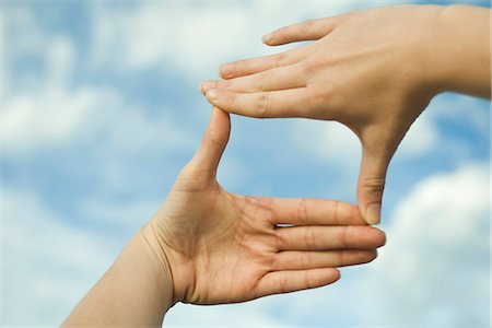 Hands making a finger frame in front of sky Stock Photo - Premium Royalty-Free, Code: 632-03651845