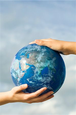 safe global concept - Two people's hands supporting one ball Stock Photo - Premium Royalty-Free, Code: 632-03651861