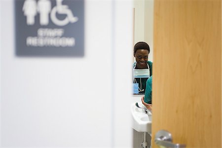 simsearch:696-03402708,k - Healthcare worker washing hands in bathroom Stock Photo - Premium Royalty-Free, Code: 632-03651918