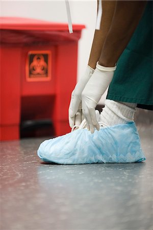 simsearch:632-05991735,k - Healthcare worker putting on disposable shoe covers Stock Photo - Premium Royalty-Free, Code: 632-03651927