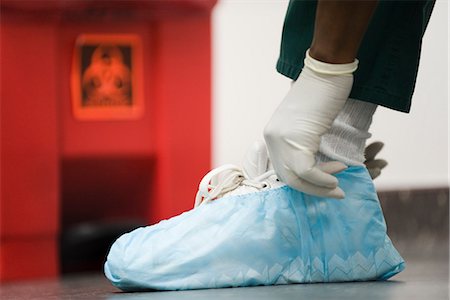 simsearch:632-05991735,k - Healthcare worker putting on disposable shoe covers Stock Photo - Premium Royalty-Free, Code: 632-03651958