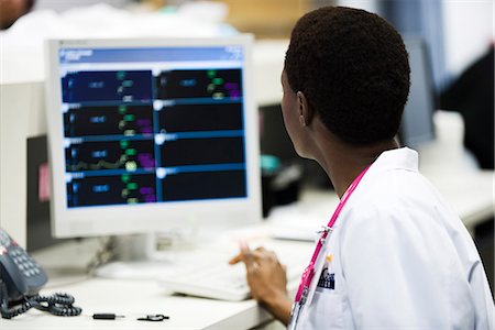 simsearch:632-03629860,k - Healthcare worker watching monitor at nurse's station Stock Photo - Premium Royalty-Free, Code: 632-03651950