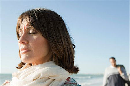 Woman standing on beach with eyes closed Stock Photo - Premium Royalty-Free, Code: 632-03652015