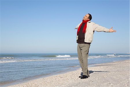 Man standing on beach with arms out and head back Stock Photo - Premium Royalty-Free, Code: 632-03652046