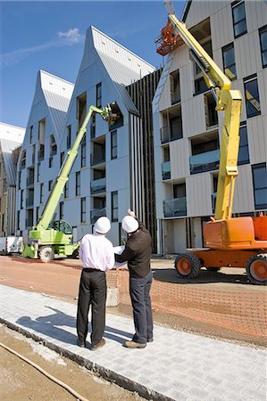 people constructing buildings - Building contractor discussing construction site with architect Stock Photo - Premium Royalty-Free, Code: 632-03652160