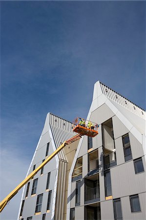 simsearch:696-03398616,k - Construction workers in cherry picker bucket working on building exterior Stock Photo - Premium Royalty-Free, Code: 632-03652177