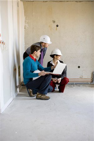 Property developer and business people using laptop at construction site Stock Photo - Premium Royalty-Free, Code: 632-03652216