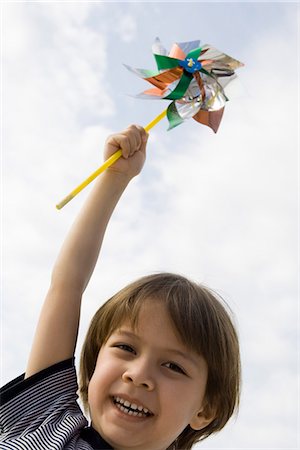 pinwheel - Boy holding up pinwheel outdoors, portrait Stock Photo - Premium Royalty-Free, Code: 632-03652268