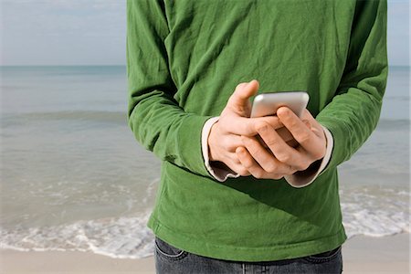 romperse el mar - Text messaging at the beach Foto de stock - Sin royalties Premium, Código: 632-03652285