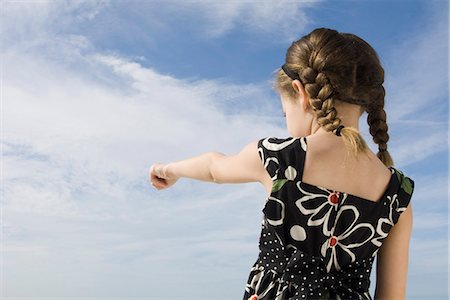 pointing at watch - Little girl pointing at the sky, rear view Stock Photo - Premium Royalty-Free, Code: 632-03652305