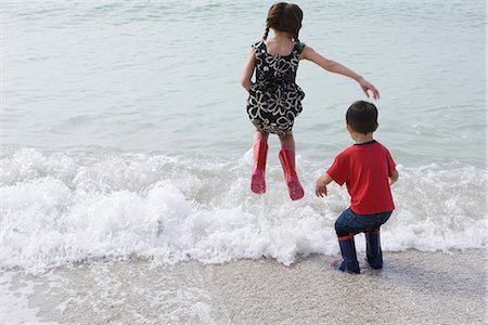 summer beach break - Children playing in surf at the beach Stock Photo - Premium Royalty-Free, Code: 632-03652307