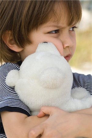 furrowed brow - Little boy hugging teddy bear Stock Photo - Premium Royalty-Free, Code: 632-03652309