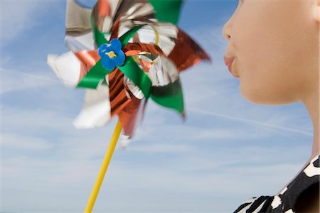 puckered lips profile - Child blowing pinwheel Stock Photo - Premium Royalty-Free, Code: 632-03652300