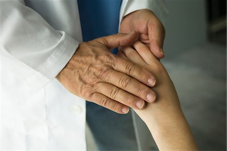 Doctor holding patient's hand Stock Photo - Premium Royalty-Free, Code: 632-03754358
