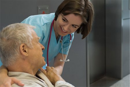 senior care inside assistance - Nurse comforting patient in hospital corridor Stock Photo - Premium Royalty-Free, Code: 632-03754395