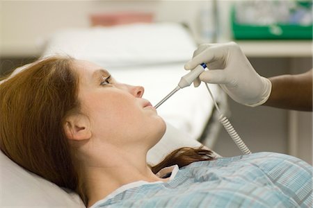 female nurse with gloves - Nursing taking patient's temperature Stock Photo - Premium Royalty-Free, Code: 632-03754404