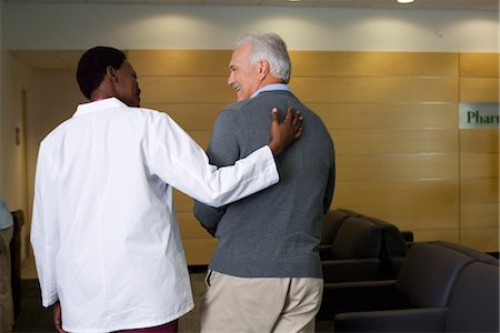 patient waiting room not kids - Doctor walking and talking with patient Stock Photo - Premium Royalty-Free, Code: 632-03754417