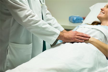 people in the hospital holding the hand of a patient - Doctor comforting patient Stock Photo - Premium Royalty-Free, Code: 632-03754412