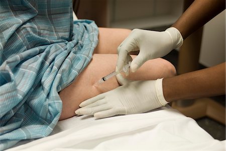 female nurse with gloves - Patient receiving shot in leg Stock Photo - Premium Royalty-Free, Code: 632-03754413