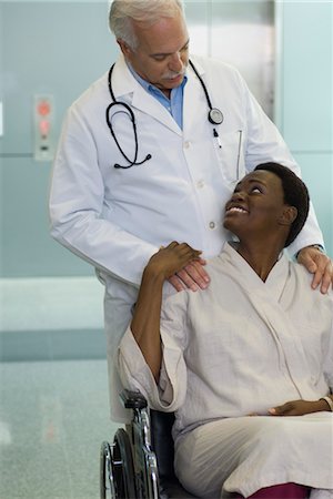 doctor patient compassion - Doctor reassuring female patient in wheelchair Stock Photo - Premium Royalty-Free, Code: 632-03754427