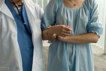 recovering - Patient holding on to nurse's arm for support Stock Photo - Premium Royalty-Free, Code: 632-03754434