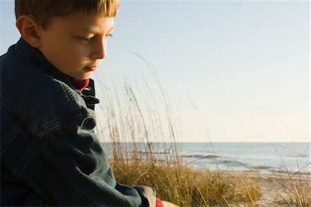 simsearch:632-05401082,k - Young boy outdoors contemplatively looking away Stock Photo - Premium Royalty-Free, Code: 632-03754469