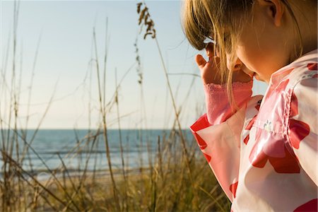 shy children - Young girl outdoors, sea in background Stock Photo - Premium Royalty-Free, Code: 632-03754508