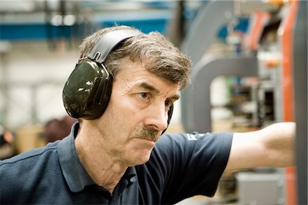 reportage style - Factory worker wearing protective headphones Stock Photo - Premium Royalty-Free, Code: 632-03754595