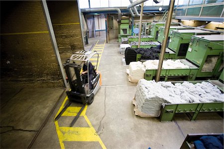 Carpet tile factory, forklift preparing fluffy fibers for processing Stock Photo - Premium Royalty-Free, Code: 632-03754598