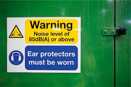 reportage style - Sign warning of high levels of noise and the need to wear ear protectors Stock Photo - Premium Royalty-Free, Code: 632-03754592