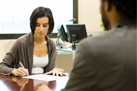 firma - Woman signing document in office Fotografie stock - Premium Royalty-Free, Codice: 632-03754705