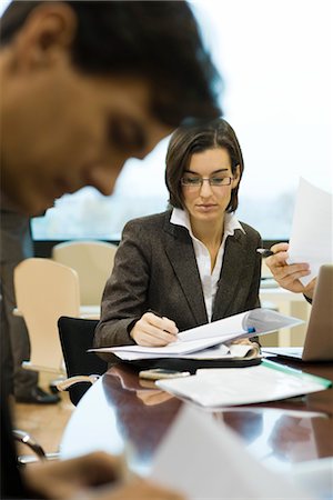 executives paper - Executives reviewing documents in meeting Stock Photo - Premium Royalty-Free, Code: 632-03754709