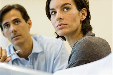 Business people looking up attentively, portrait Stock Photo - Premium Royalty-Free, Code: 632-03754740